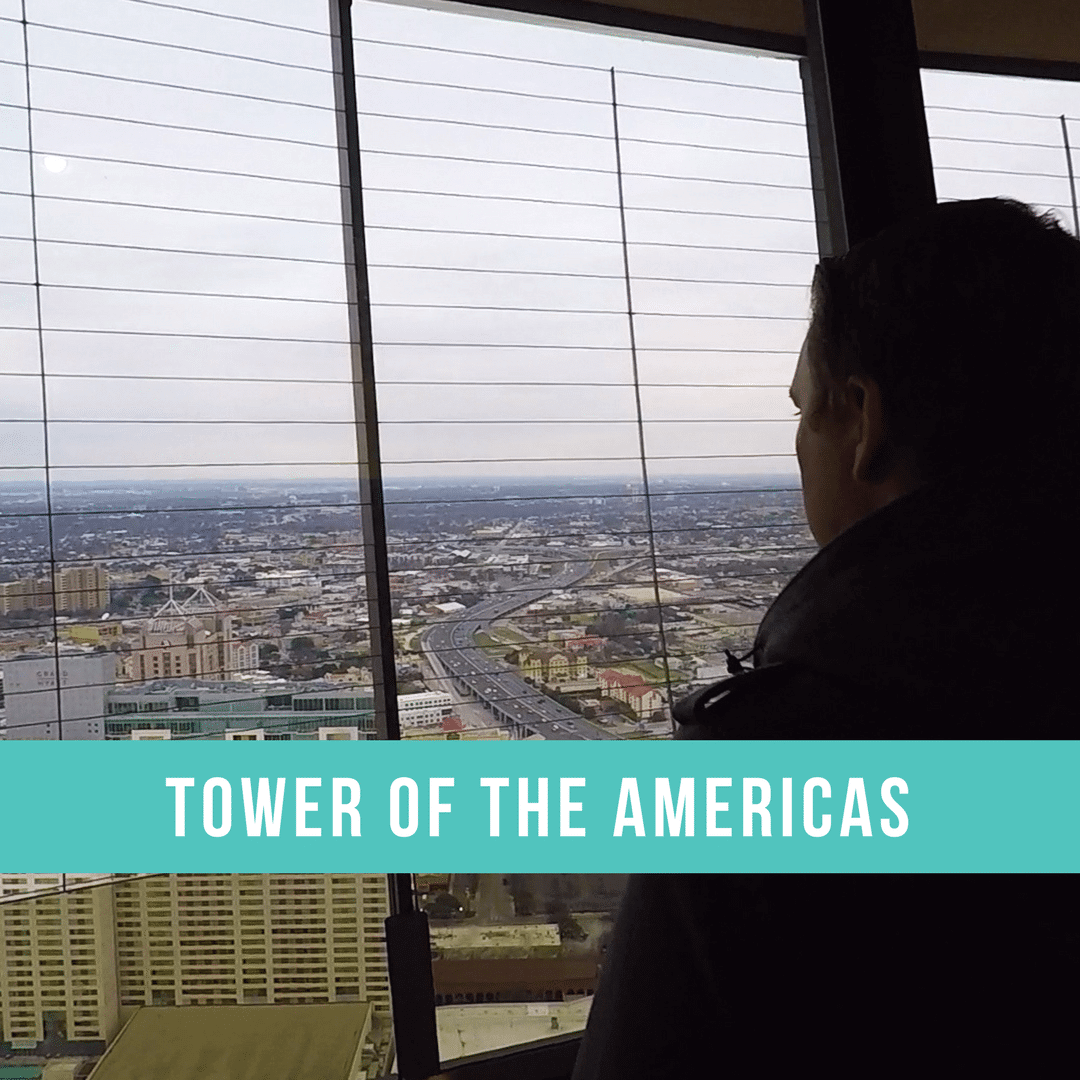 Man looking out of the top of the Tower of the Americas in San Antonio