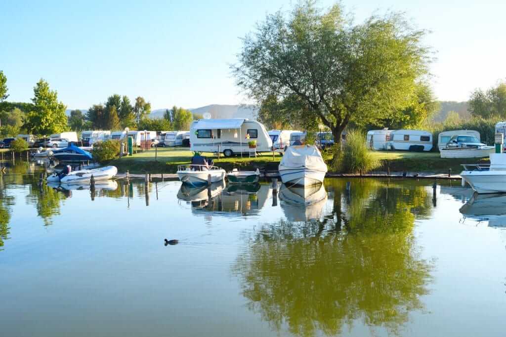 People using their campground membership to park their RV at a RV resort on a lake.