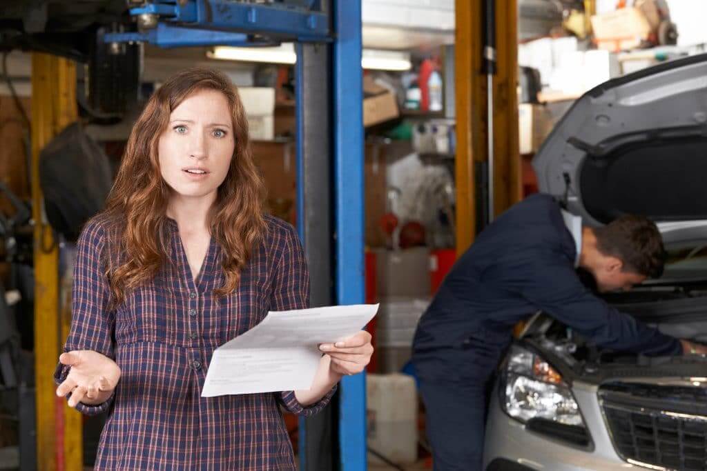 Shocked Female Customer Looking At RV Repair Bill