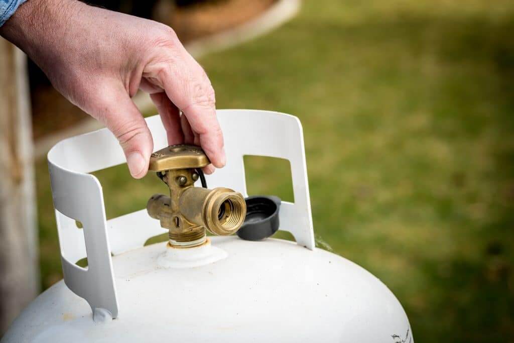 Brass valve closed on a DOT propane tank.
