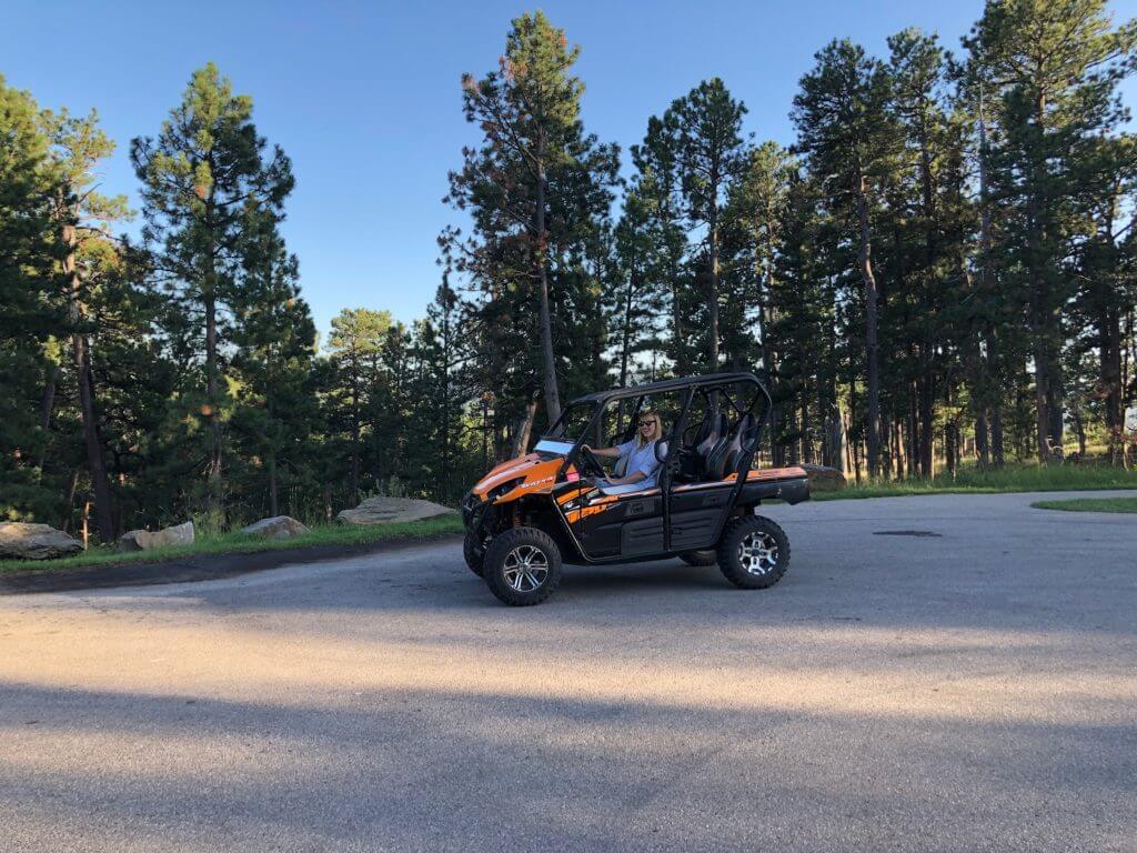 Rae driving an ATV in the black hills of South Dakota.