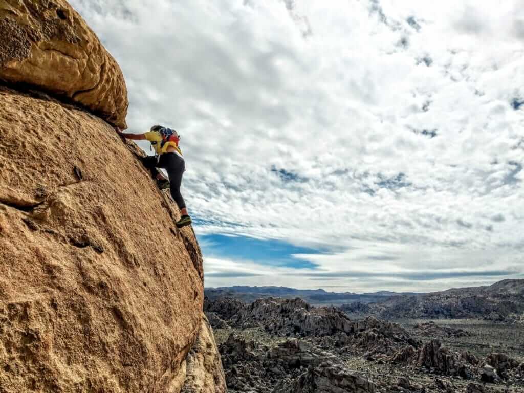 rock climber on a rock in Hidden Valley at Joshua Tree National Park 