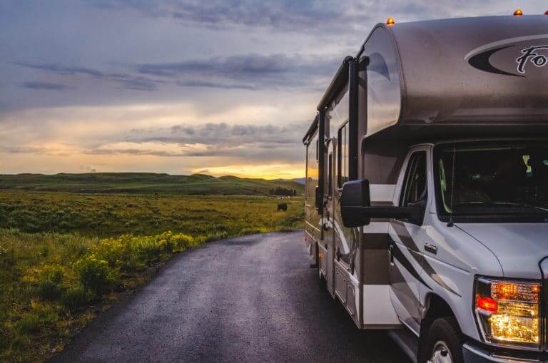 RV in field with sunset in background