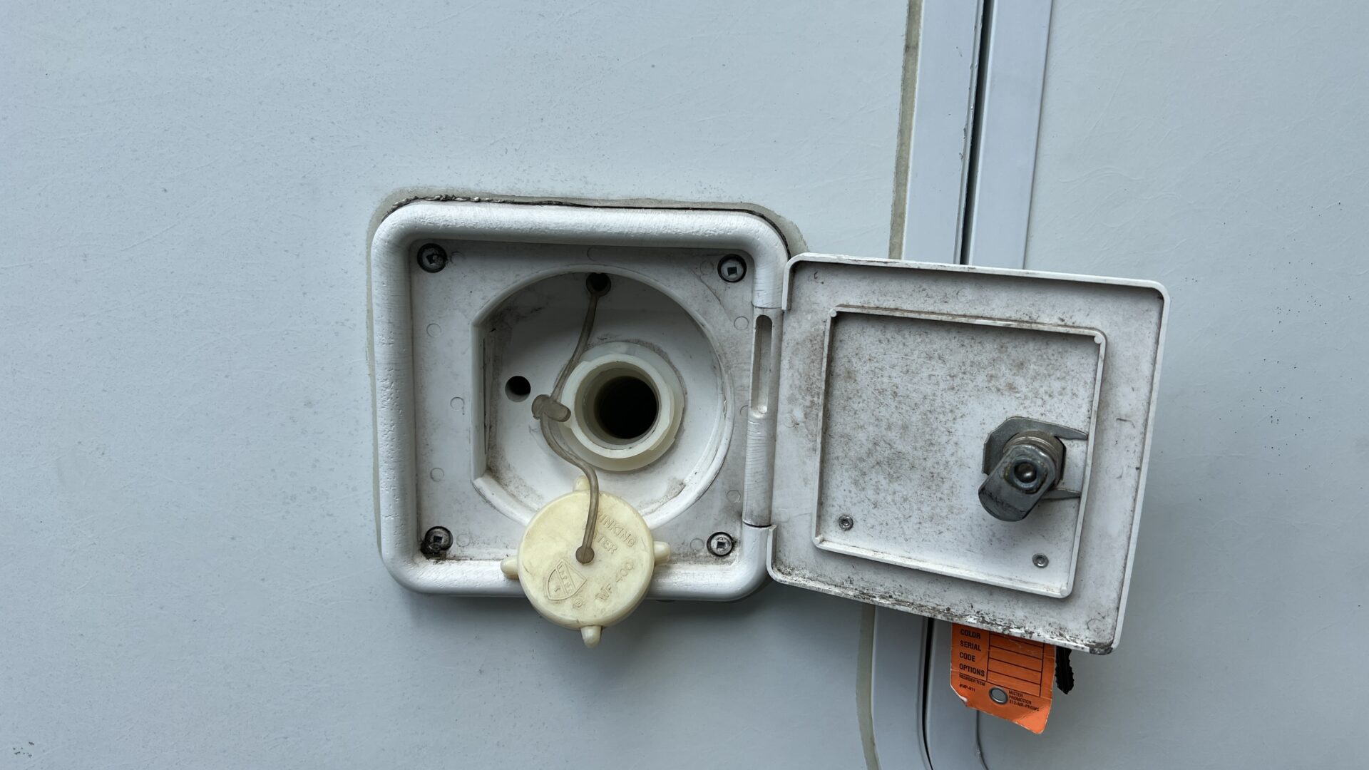Fresh water tank inlet on side of RV