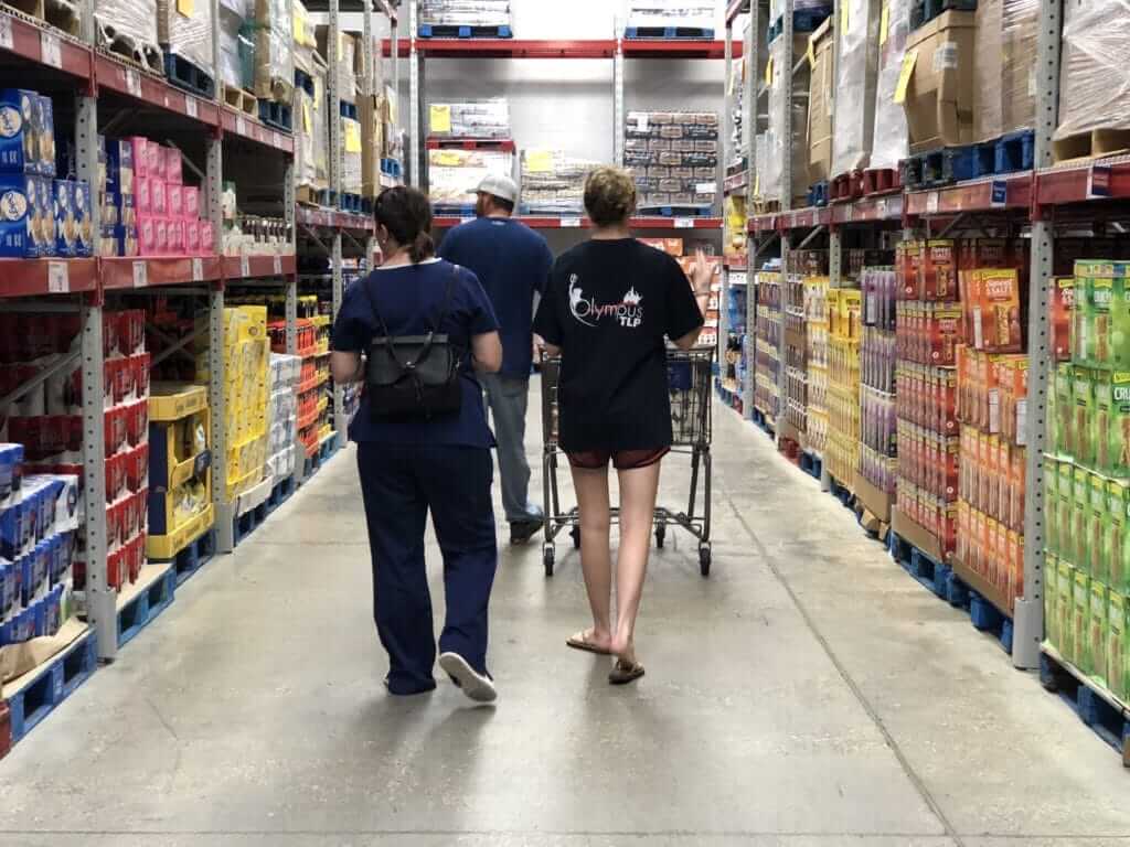 Family walking down aisle at bulk store
