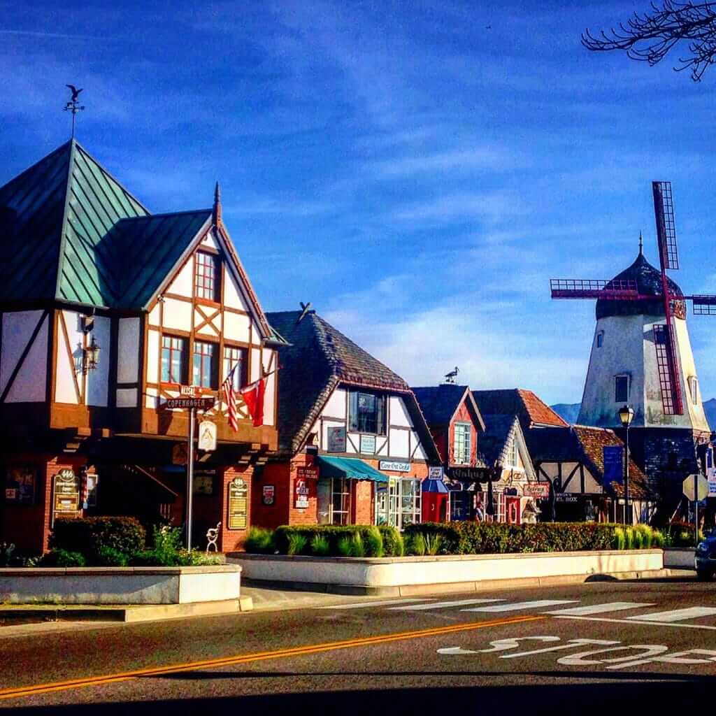 Danish style buildings with a windmill in the background, this is Solvang, one of best things to do in Santa Barbara