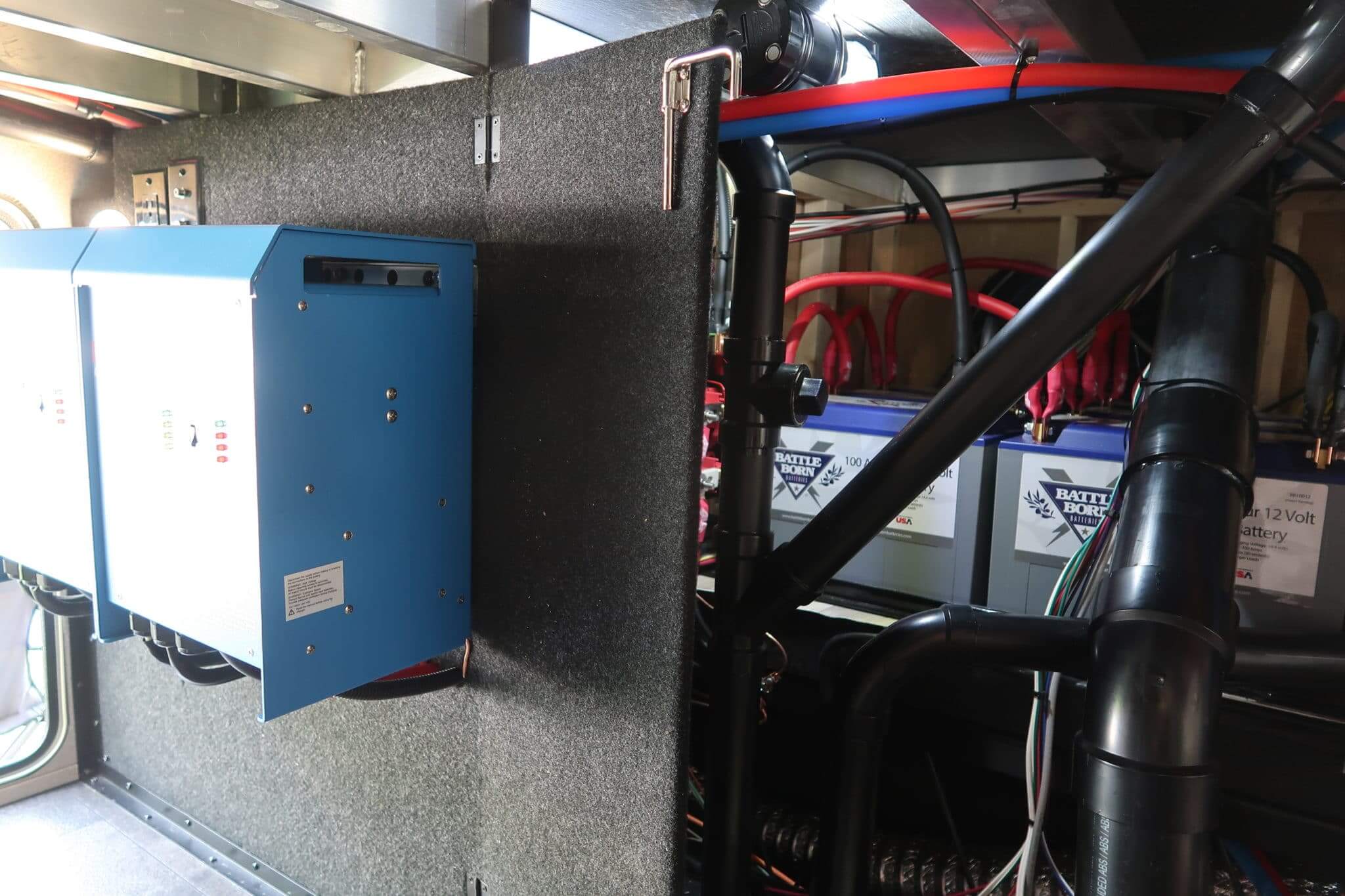 Victron inverters and Battle Born lithium deep cycle battery installed in the storage of a Grand Design Solitude RV