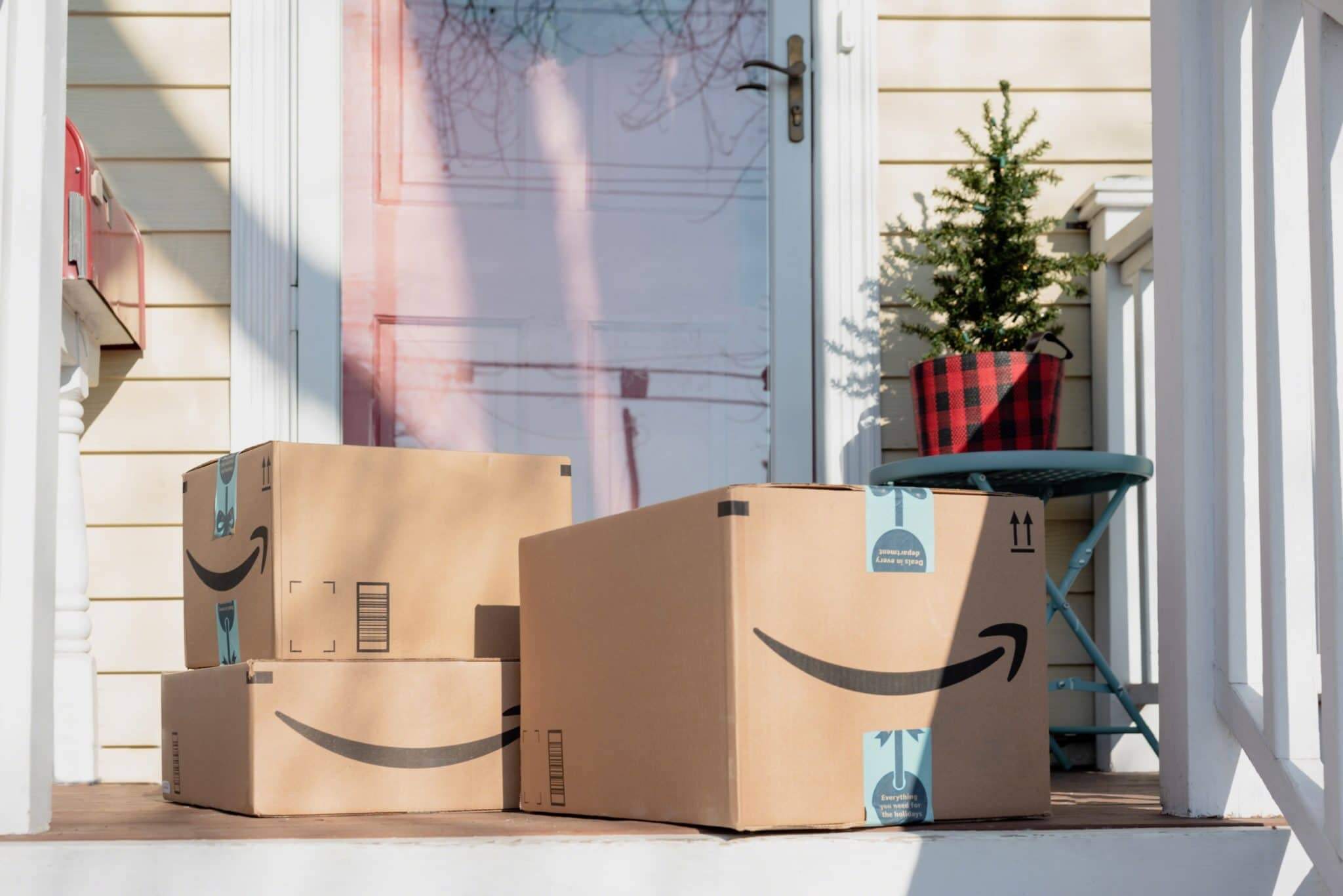 pile of amazon boxes at doorstep