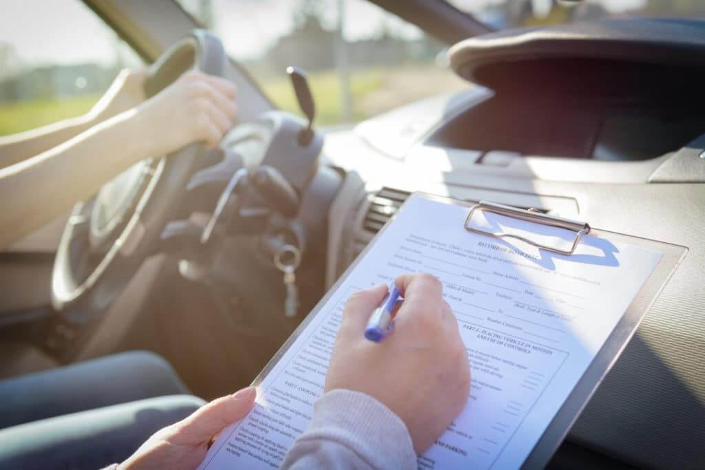 Person taking drivers test for a special license with test supervisor in the passenger seat