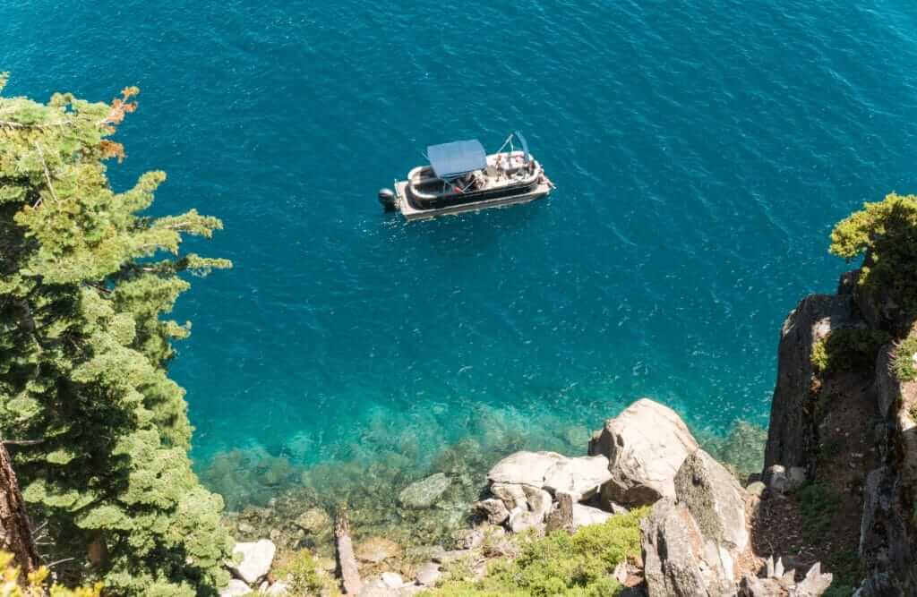 Boat on the crystal clear blue water of Emerald Bay in Lake Tahoe