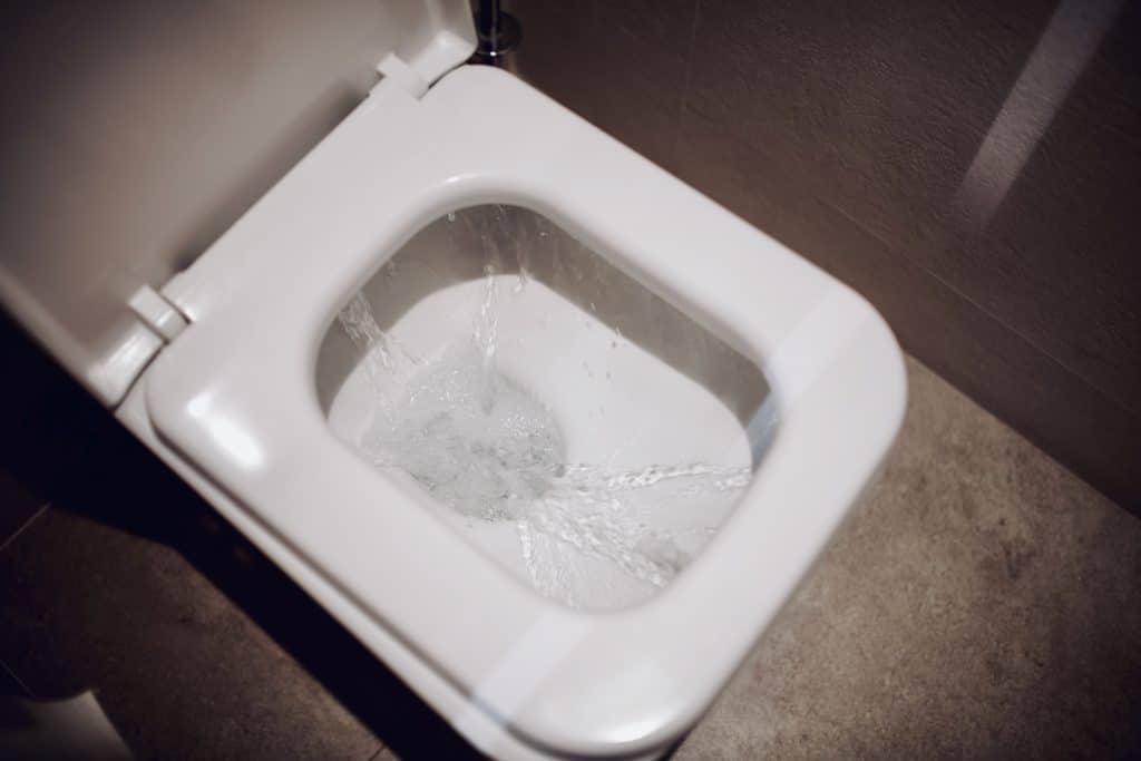 A white toilet flushing water. You have to troubleshoot some issues when you are doing RV toilet repair. 