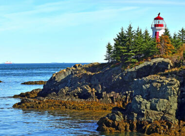 The atlantic ocean surrounds an island and lighthouse that hold the only US National Park in Canada.