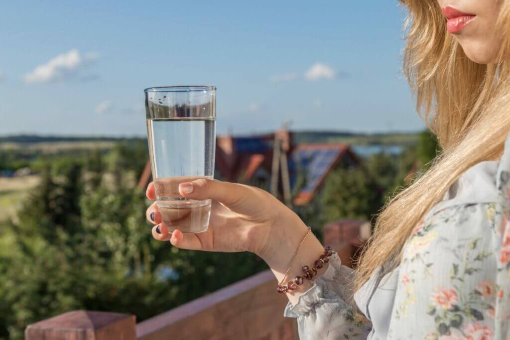 girl holding glass of clean drinking water