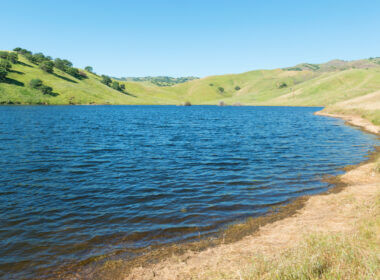 San Luis Reservoir has green rolling hills and deep blue water making it the perfect place to camp in central california!