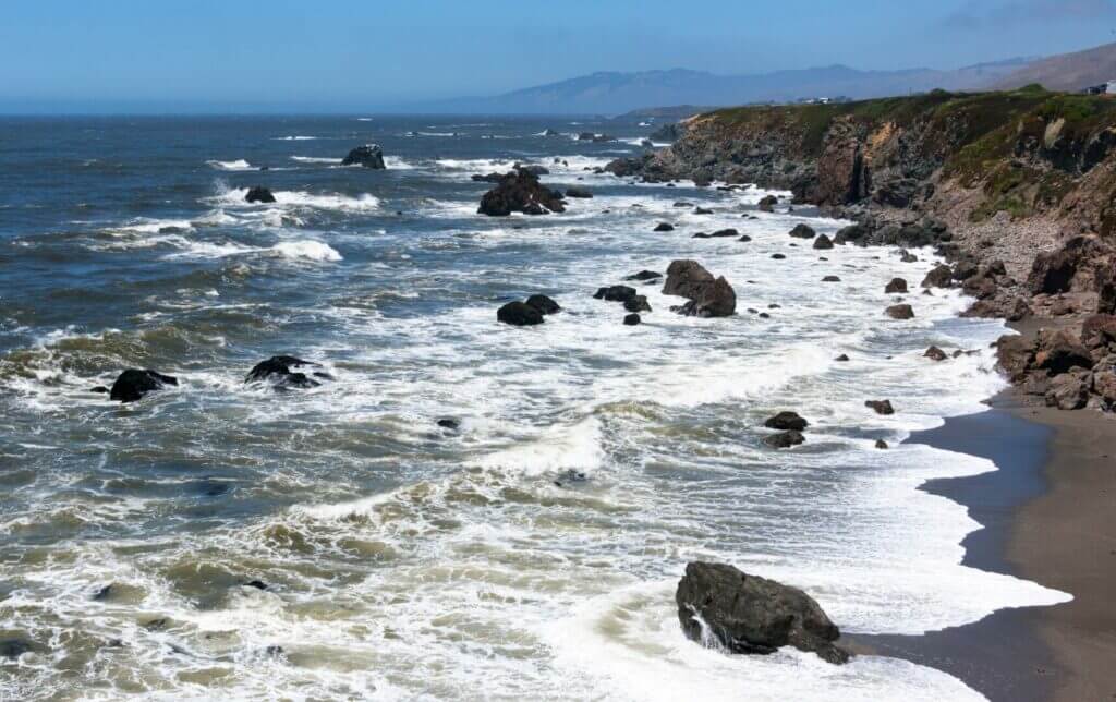 Pebble beach with waves crashing, this beach is only a short drive when Monterey camping.