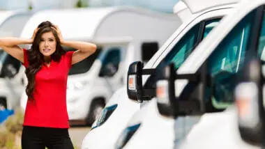A woman with a red shirt stands in front of a row of RVs and she looks very stressed, <b>4 bike hitch rack for rv</b>. Is 2021 the worst year to buy an RV?