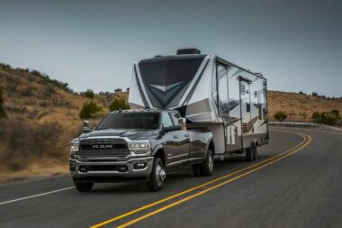 Ram 3500 vs Ram 2500, which one is better for towing your RV? This picture is a Ram 3500 towing a fifth wheel down a desert highway.