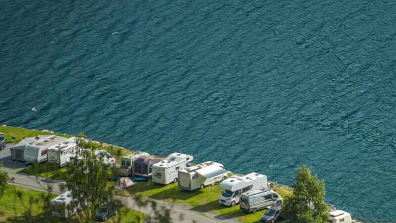 A gorgeous aerial view of an RV park with RVs camped along an oceanside cliff, but what is the average cost of an RV park?