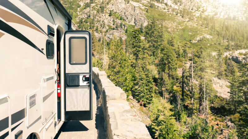 An RV door is open as theyve pulled off to the side of the road and they dont have to worry about getting locked out with the RVLock keyless entry.