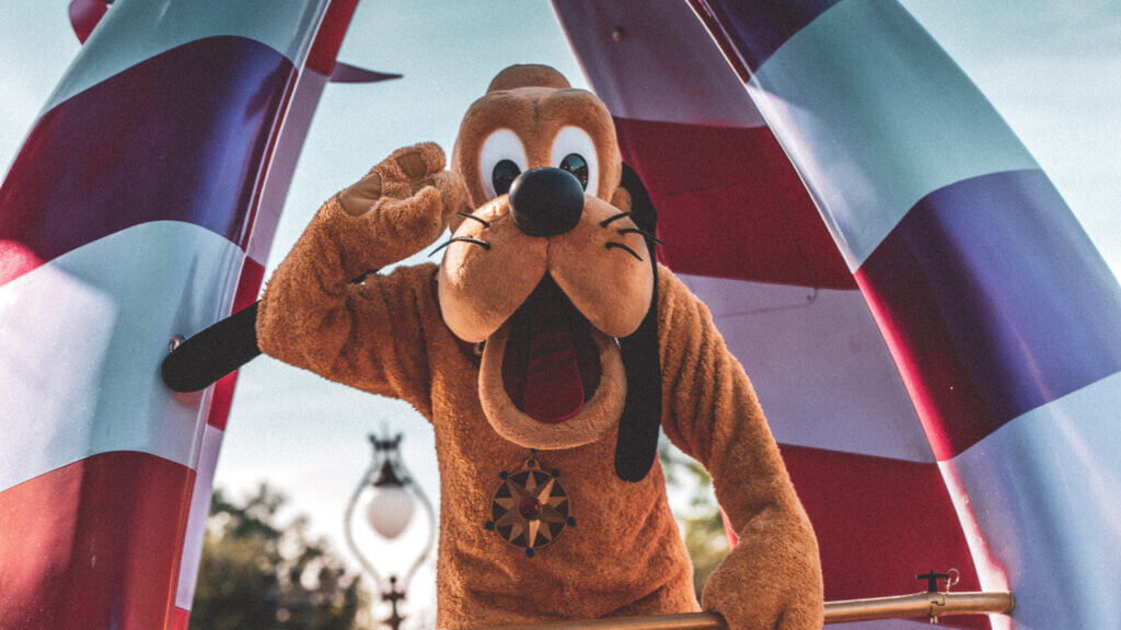 Pluto greets guests at Disney World.