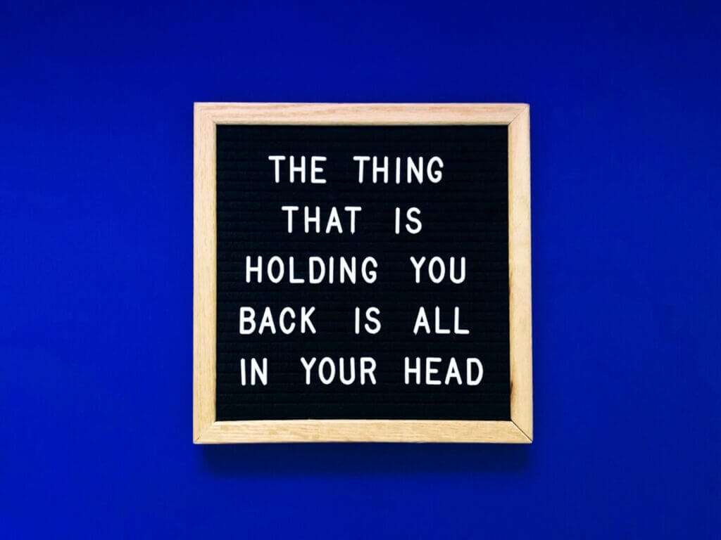 an inspirational quote about full-time rv living on a letter board that says "the thing that is holding you back is all in your head"