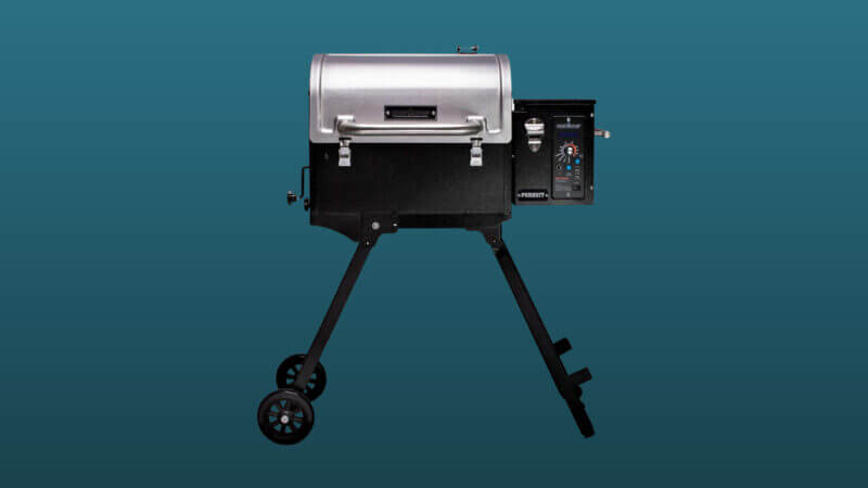 A camp chef portable pellet grill set against a dark blue backdrop.