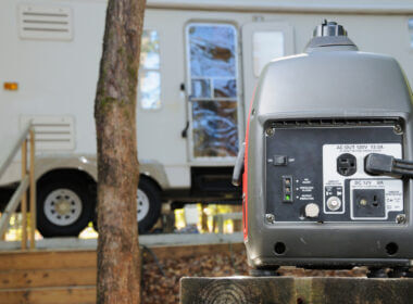 A portable generator powers an RV from a safe distance.