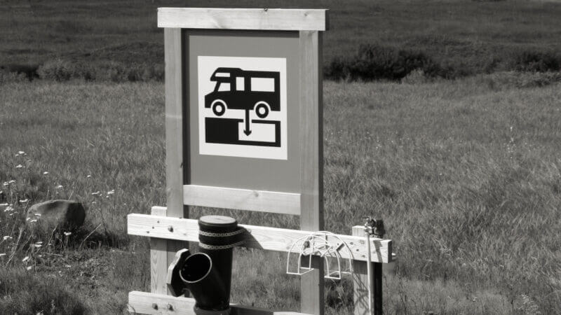 A black and white dump station sign and there are lots of resources to help you find a dump station for free!