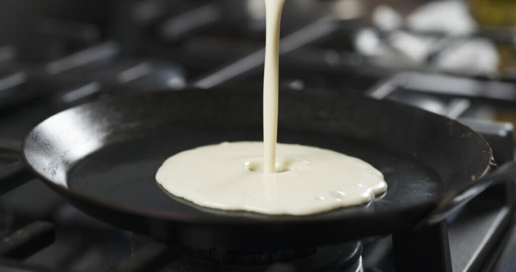 Pancake batter being poured on a hot pan using the Blackstone breakfast kit