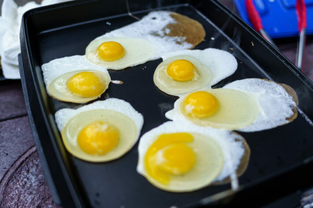 Messy eggs on a griddle that clearly weren't made using the Blackstone breakfast kit