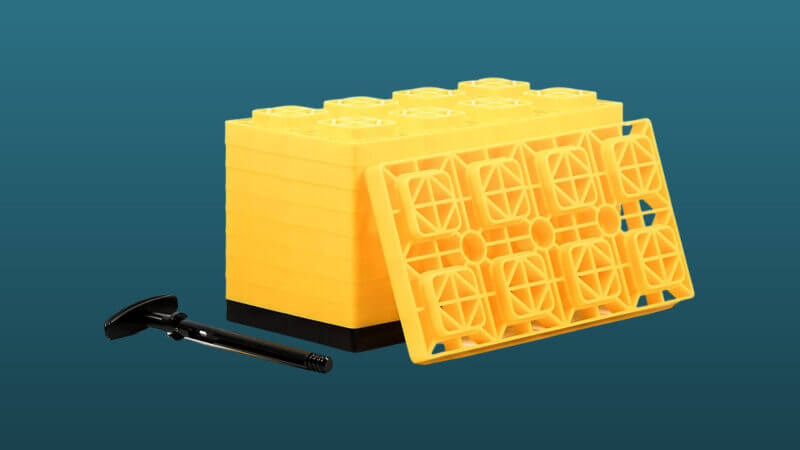 Yellow Camco leveling blocks set against a blue background.