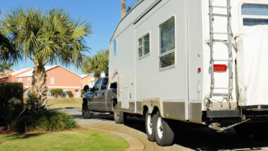 A truck reverses their RV into the driveway without anxiety