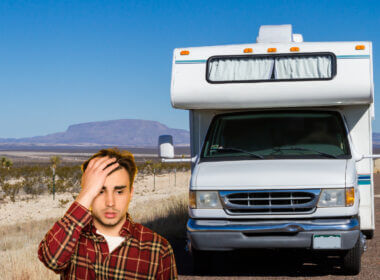 A man stands in front of his RV and regrets investing money into an FMCA membership.