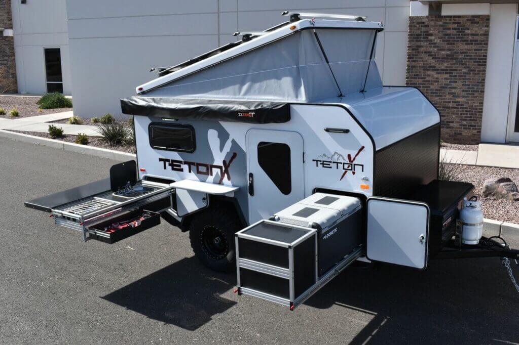 An off-road trailer all setup in the parking lot to show off it's features