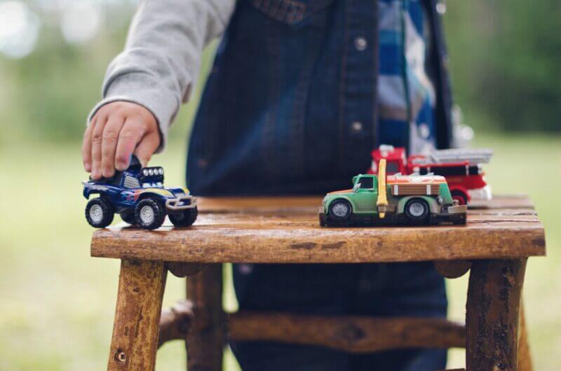 kid playing with toy trucks