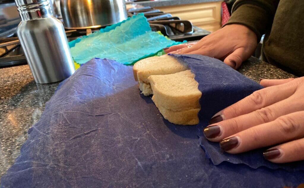A woman wrapping a tuna sandwich. This simple no cook camping recipe is quick and filling.