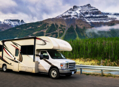 An RV is parked in front of a gorgeous bucket list mountain destination.