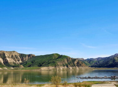 A blue sky day at Lake Piru is not uncommon with rolling hills along the shoreline.