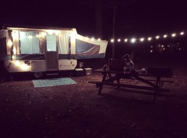 Pop-up camper camping at night.