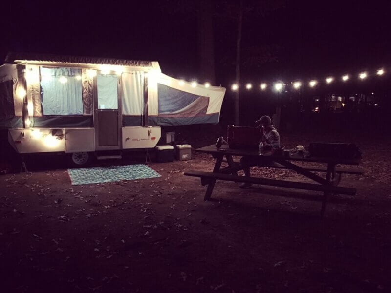 Pop-up camper camping at night.