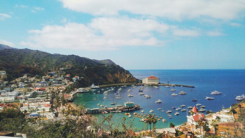 Catalina Island from above with houses on the mountain and boats in the water