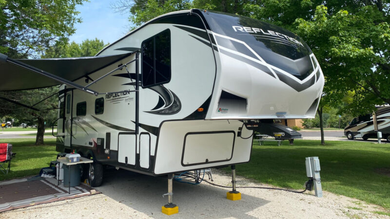A Grand Design Reflection fifth wheel is camped out and has a spacious floorplan perfect for full time living.