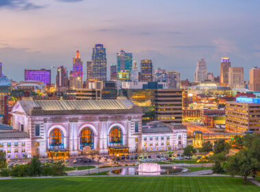 A skyline view of Kansas City in the setting sun glow.
