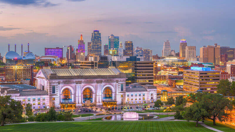A skyline view of Kansas City in the setting sun glow.