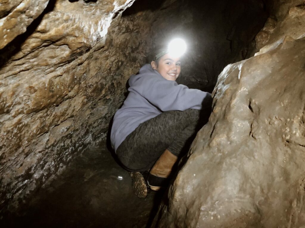 Young woman exploring one of the many caves in Shawnee National Forest.