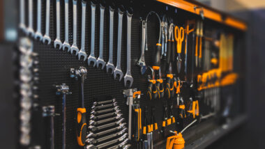 An organized wall of tools to keep things clean in an RV basement.