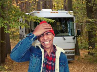 A man regrets parking his large motorhome in a small space surrounded by trees.