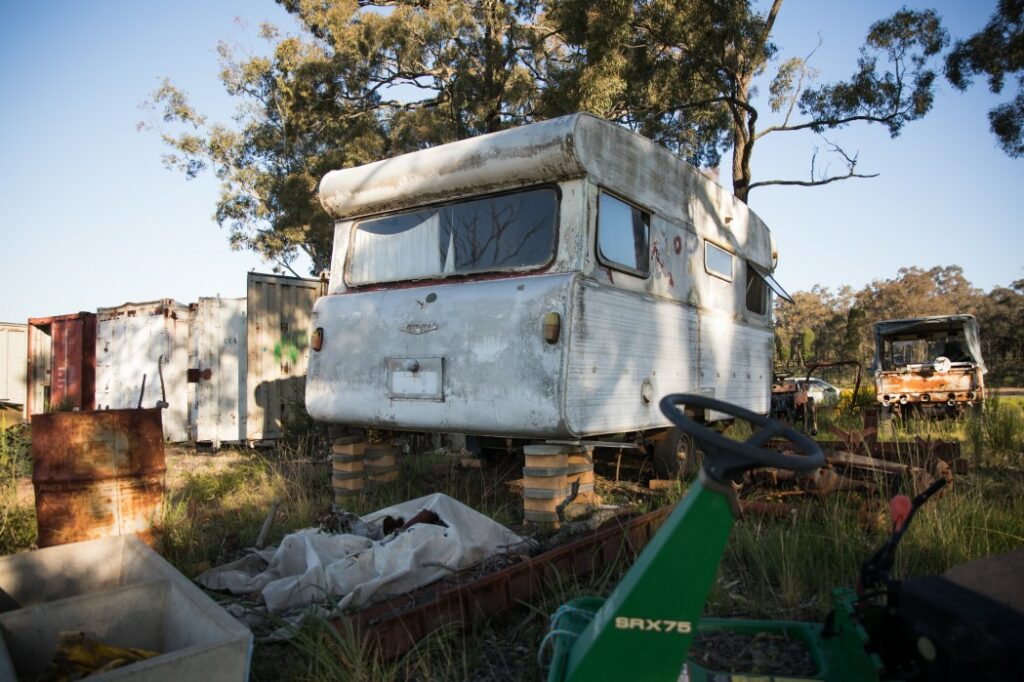 An old broken down trailer that has experienced RV depreciation so much it's not worth more than a place in a junkyard.