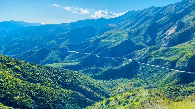 Aerial view of a road winding through the mountains of Los Padres National Forest.