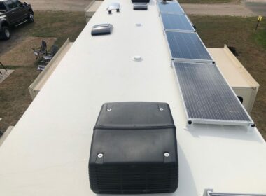 Solar panel kit is installed and lined up on the roof of an RV.